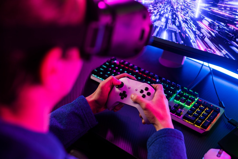 gamer using controller at rgb gaming setup